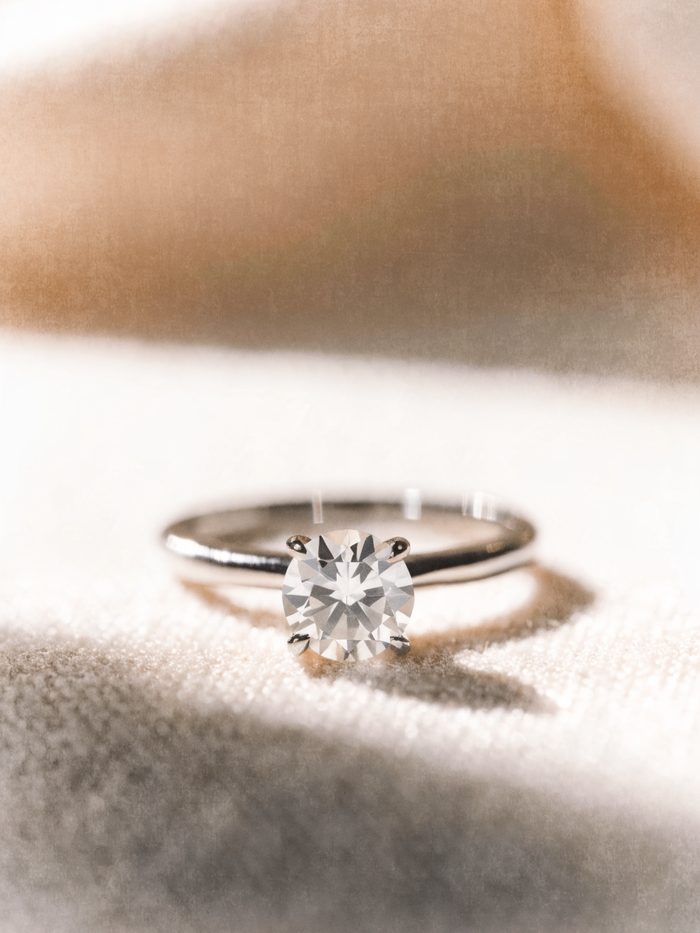 A round brilliant moissanite solitaire ring on linen