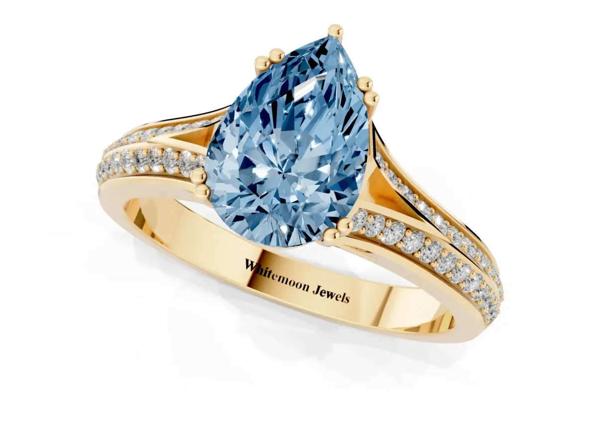 Fancy Blue Pear Cut Diamond Split Shank Engagement Ring with Pavé Band Yellow gold