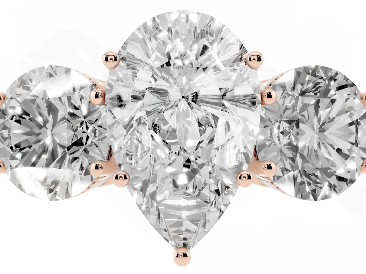 Three-Stone Pear Cut Diamond Engagement Ring with Prong Setting on a Classic Band Rose gold