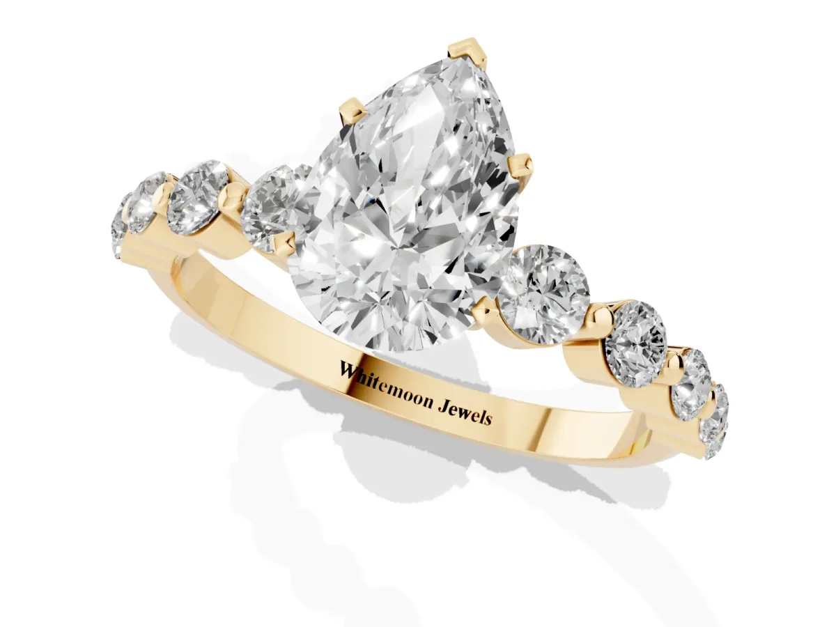 Pear Cut Solitaire Diamond Ring with Pave Band and Four-Prong Setting Yellow gold