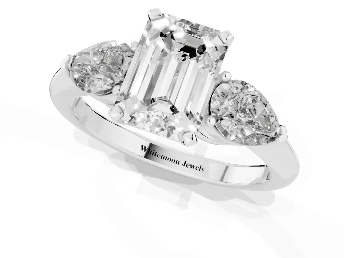 Three-Stone Emerald Cut Diamond Ring with Pear Side Stones and Four-Prong Setting Platinum