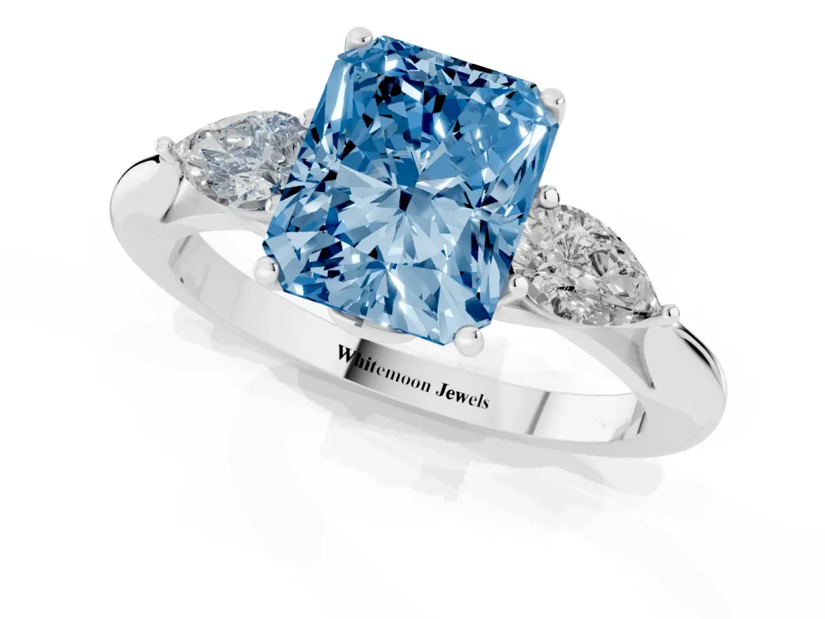 Fancy Blue Radiant Cut Diamond Three-Stone Ring with Pear Side Stones and Prong Setting Platinum