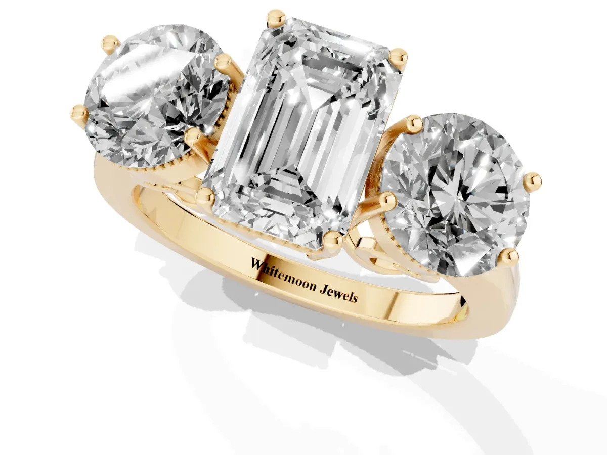 Three-Stone Emerald Cut Diamond Engagement Ring with Prong Setting on a Classic Band Yellow gold