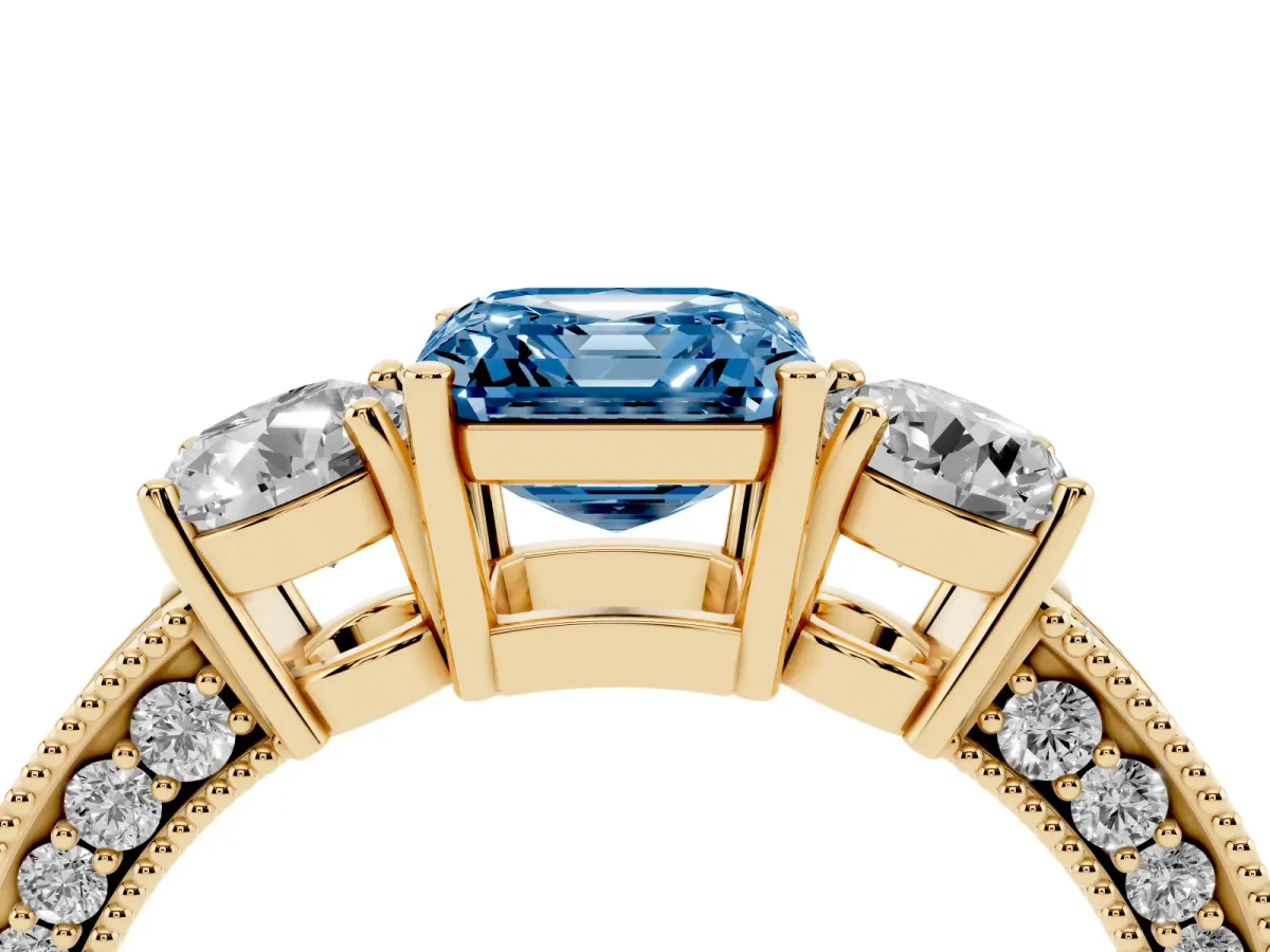 Fancy Blue Asscher Cut Three-Stone Diamond Ring with Pavé Band and Four-Prong Setting Yellow gold