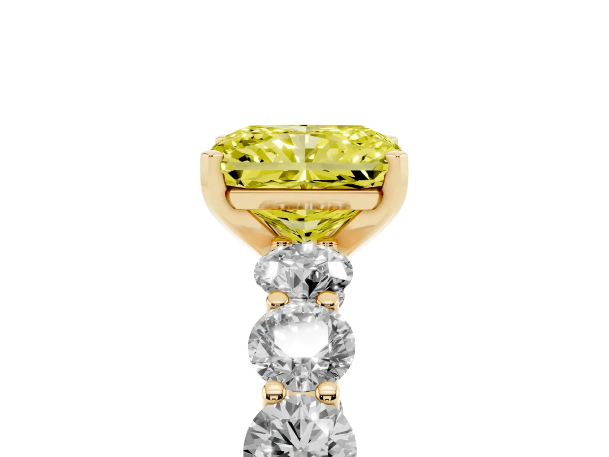 Fancy Yellow Radiant Cut Diamond Prong Setting with Side Stones on a Pave Band Yellow gold