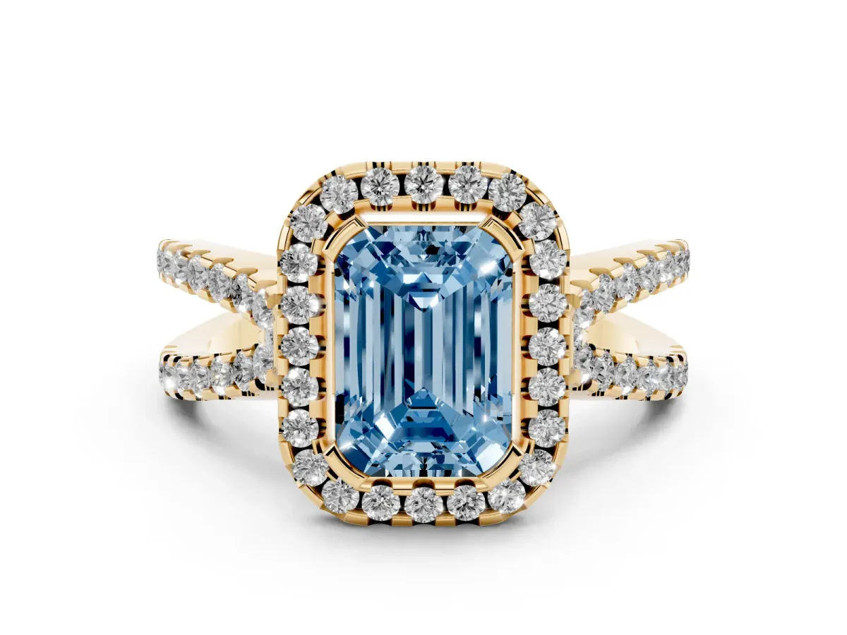 Fancy Blue Emerald Cut Diamond Halo Ring with Split Shank Pavé Band and Prong Setting Yellow gold