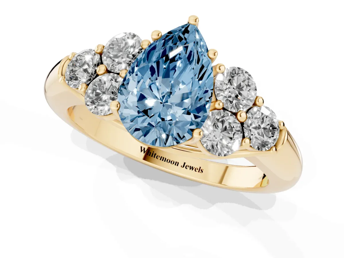 Fancy Blue Pear Cut Cut Diamond Cluster Ring with Round Accent Stones and Prong Setting on a Classic Band Yellow gold