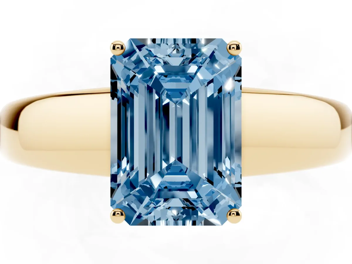 Fancy Blue Emerald Cut Solitaire Diamond Ring with Tapered Band and Four-Prong Setting Yellow gold