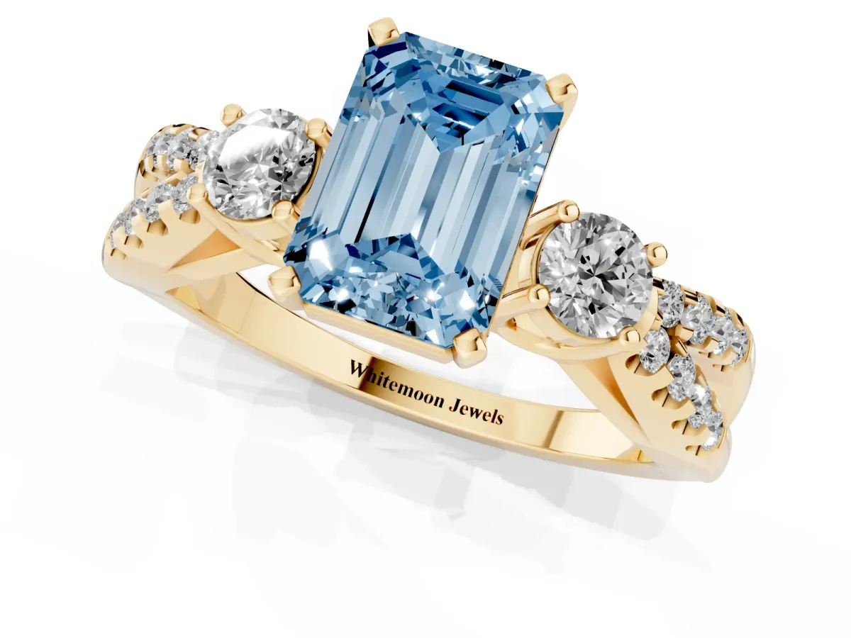 Fancy Blue Emerald Cut Diamond Three-Stone Ring with Pavé Split Shank and Four-Prong Setting Yellow gold