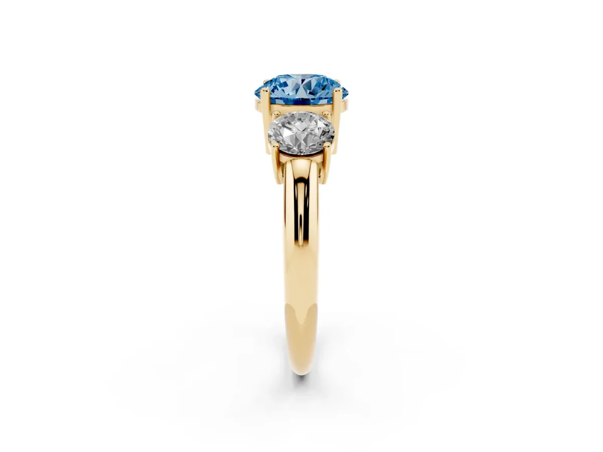 Fancy Blue Three-Stone Round Cut Cut Diamond Engagement Ring with Prong Setting on a White Gold Band Yellow gold
