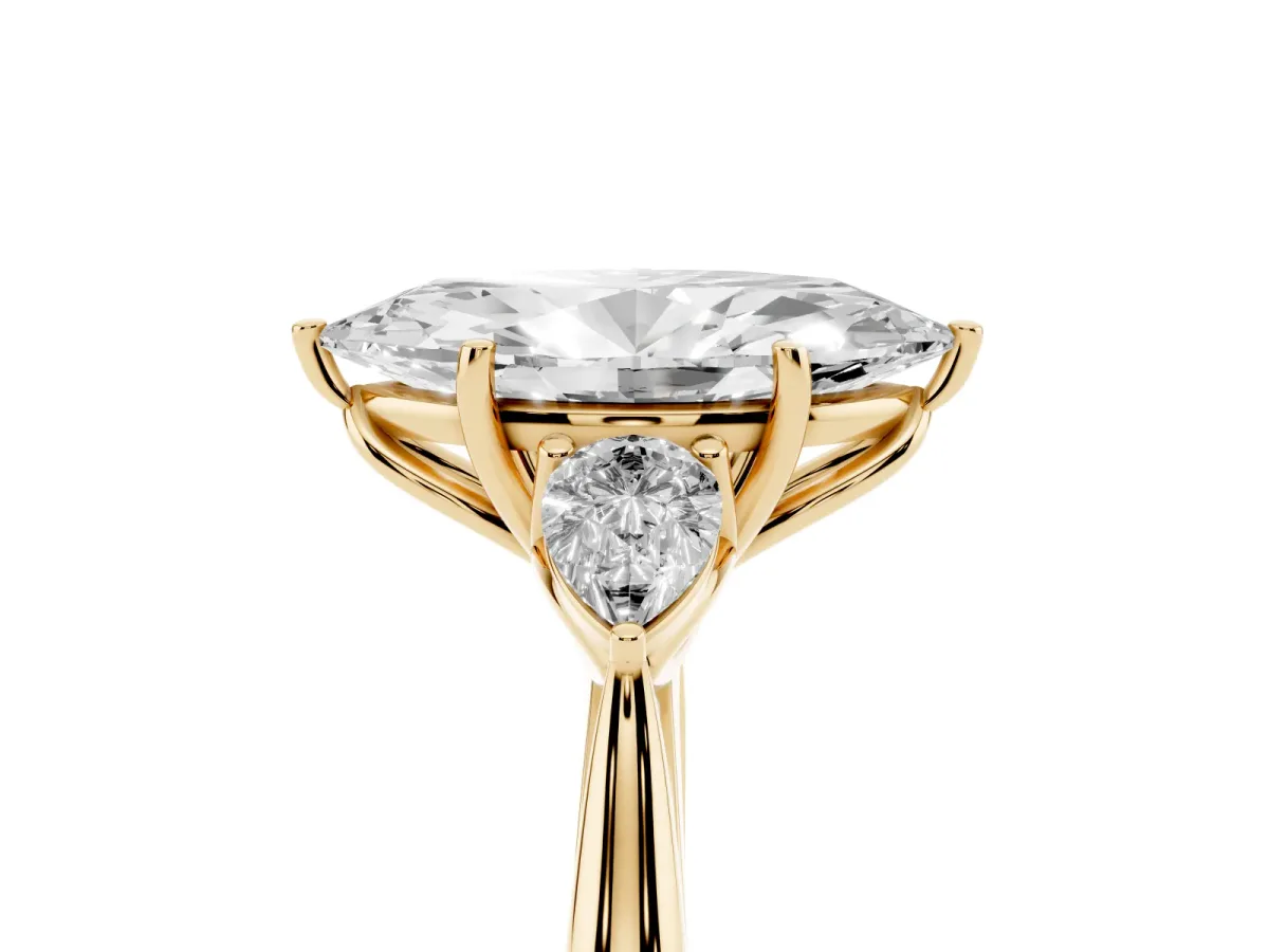 Three-Stone Marquise Cut Diamond Ring with Pear Side Stones in Four-Prong Setting Yellow gold