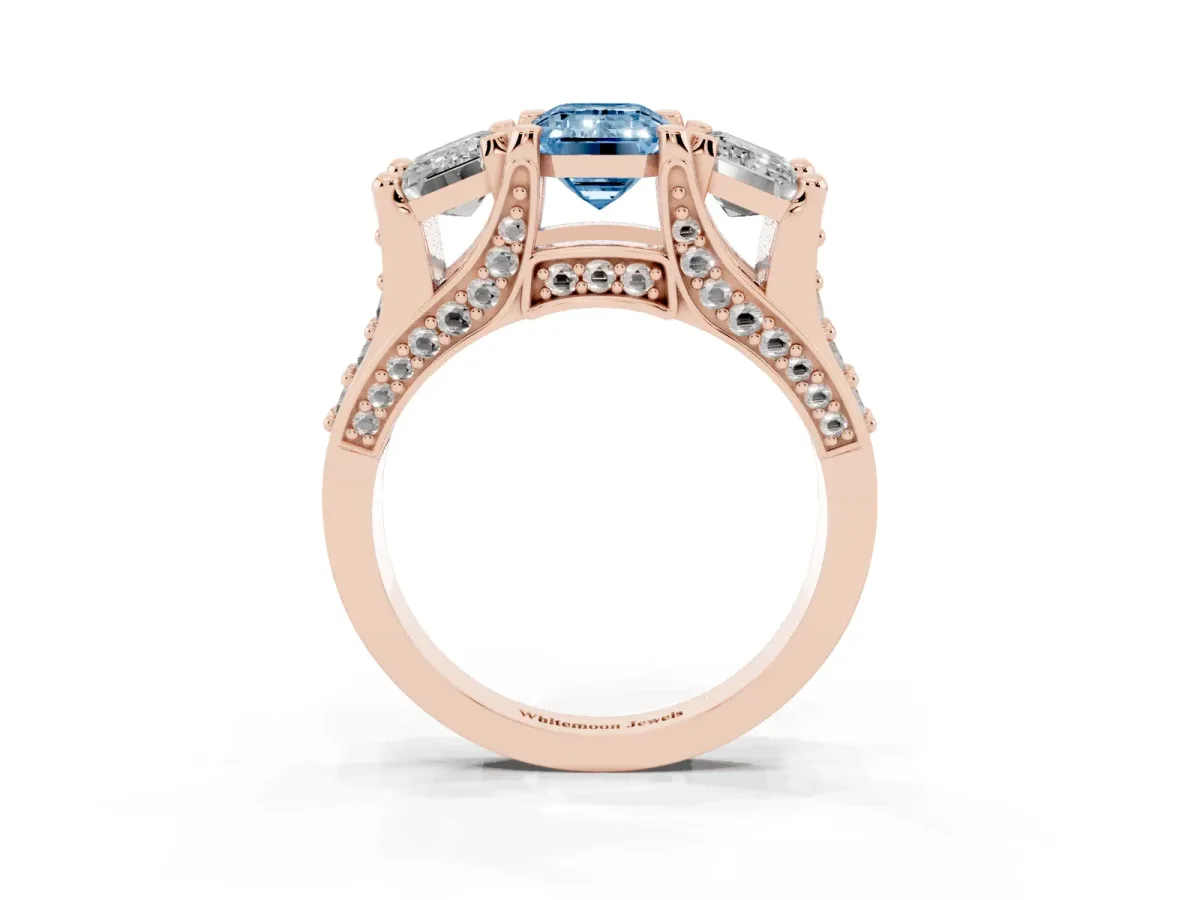 Fancy Blue Emerald Cut Diamond Three-Stone Ring with Channel Set Band and Four-Prong Setting Rose gold