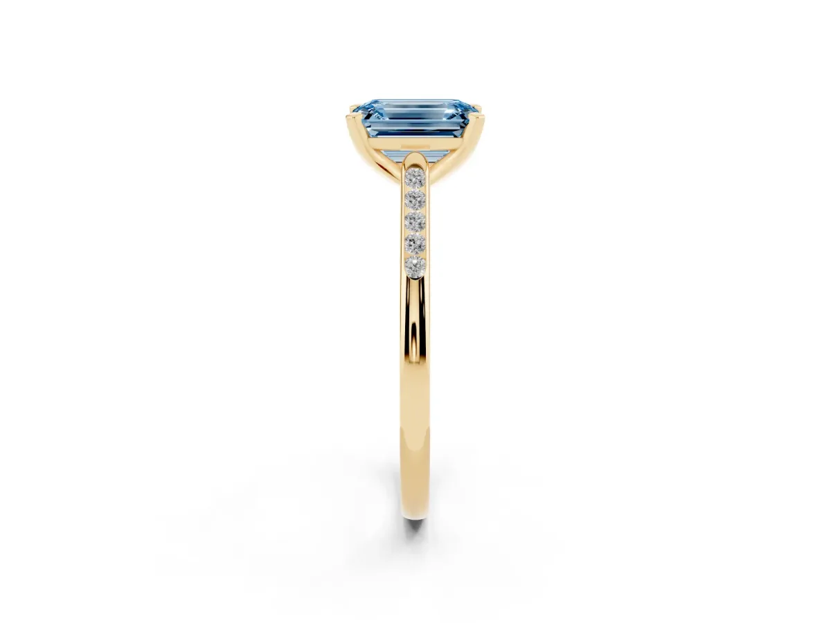 Fancy Blue Emerald Cut Diamond Solitaire Ring with Channel Set Round Band and Prong Setting Yellow gold