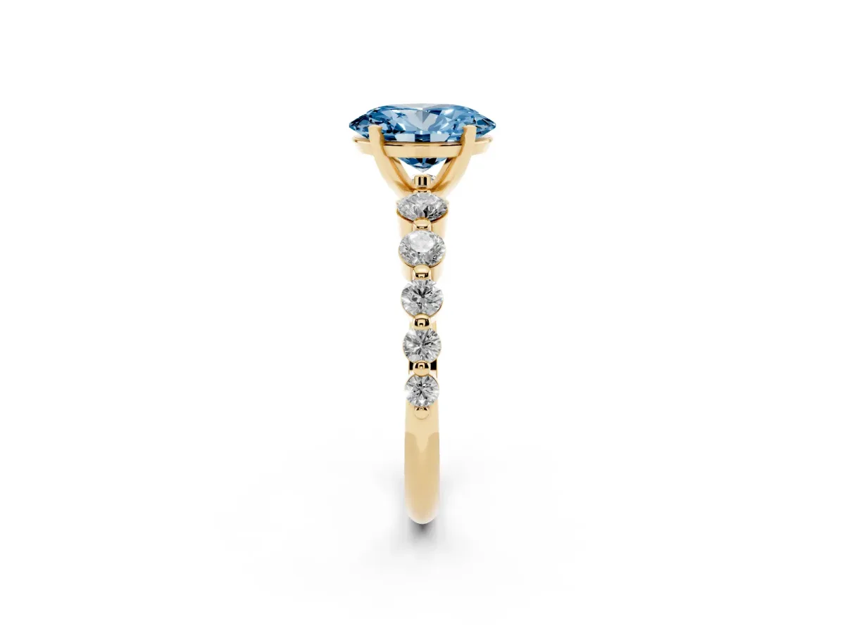 Fancy Blue Oval Cut Solitaire Diamond Ring with Pave Band and Four-Prong Setting Yellow gold