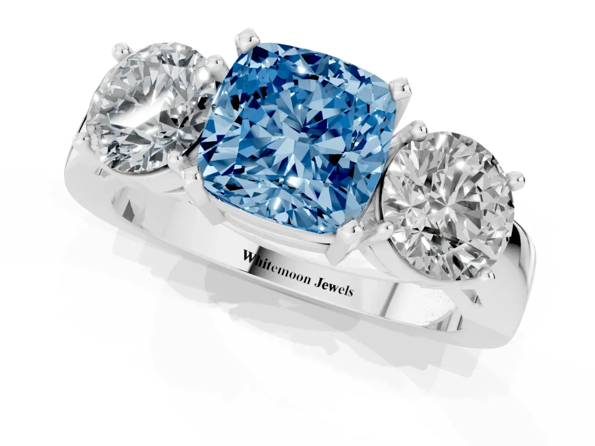 Fancy Blue Three-Stone Cushion Cut Diamond Ring with Round Side Stones, Classic Band, and Four-Prong Setting White gold