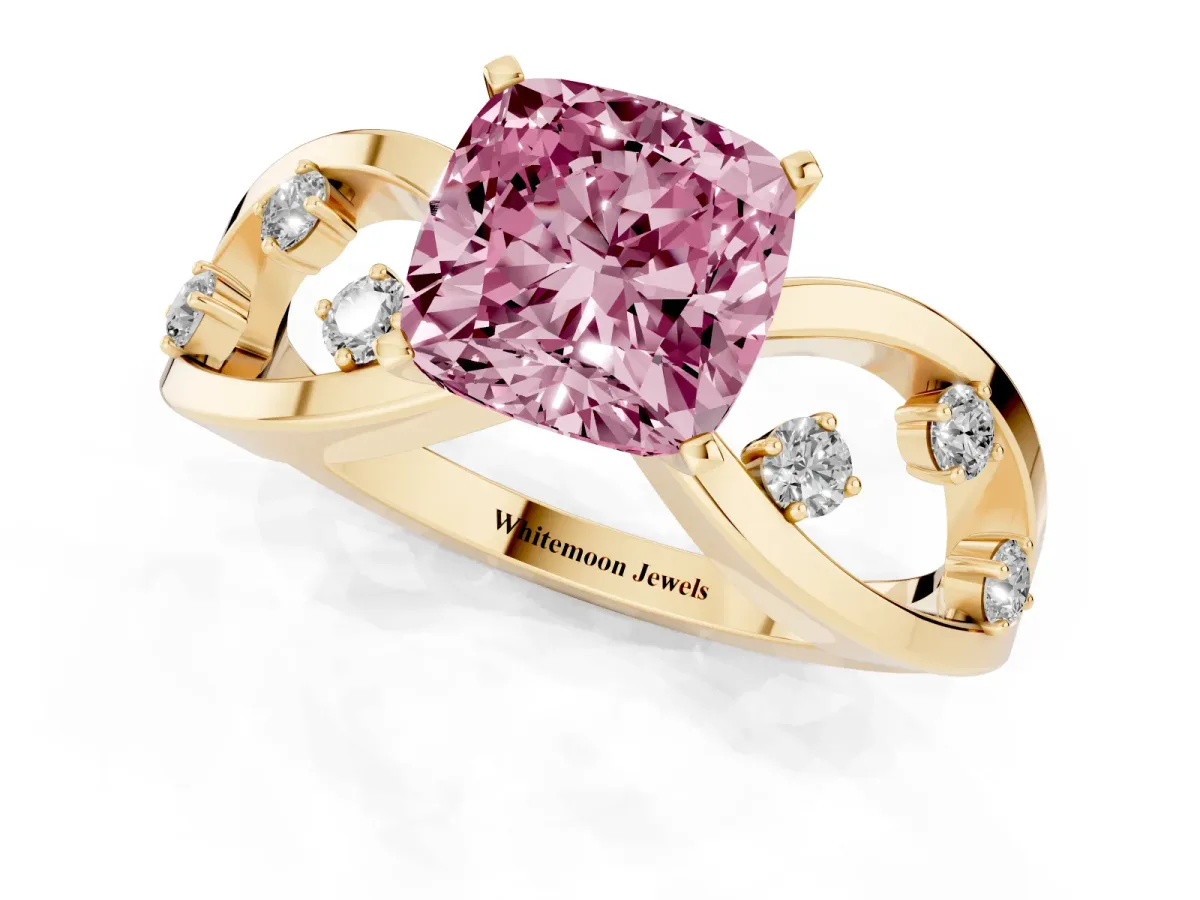 Fancy Pink Cushion Cut Cut Solitaire Diamond with Side Stones on Criss-Cross Band and Four-Prong Setting Yellow gold