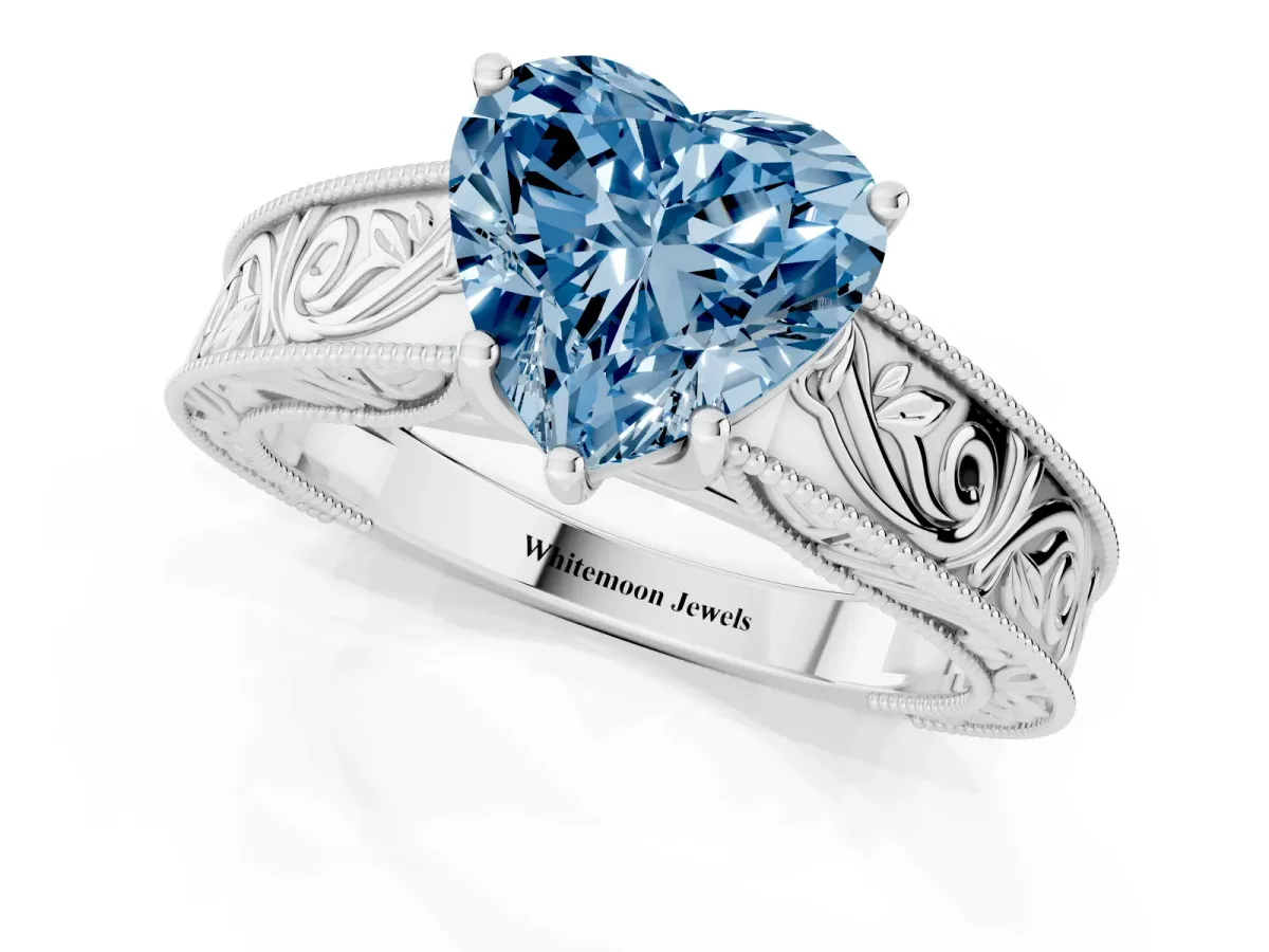 Fancy Blue Heart Cut Diamond Solitaire Ring with Engraved Band and Four-Prong Setting Silver