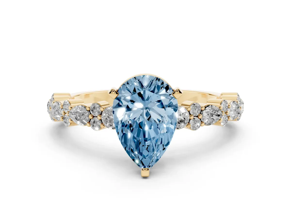 Fancy Blue Pear Cut Diamond Side Stone Solitaire Ring with Round and Four-Prong Setting Yellow gold