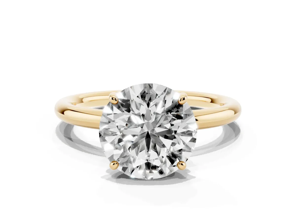 Round Cut Solitaire Diamond Ring with Four-Prong Setting on a Plain Band Yellow gold