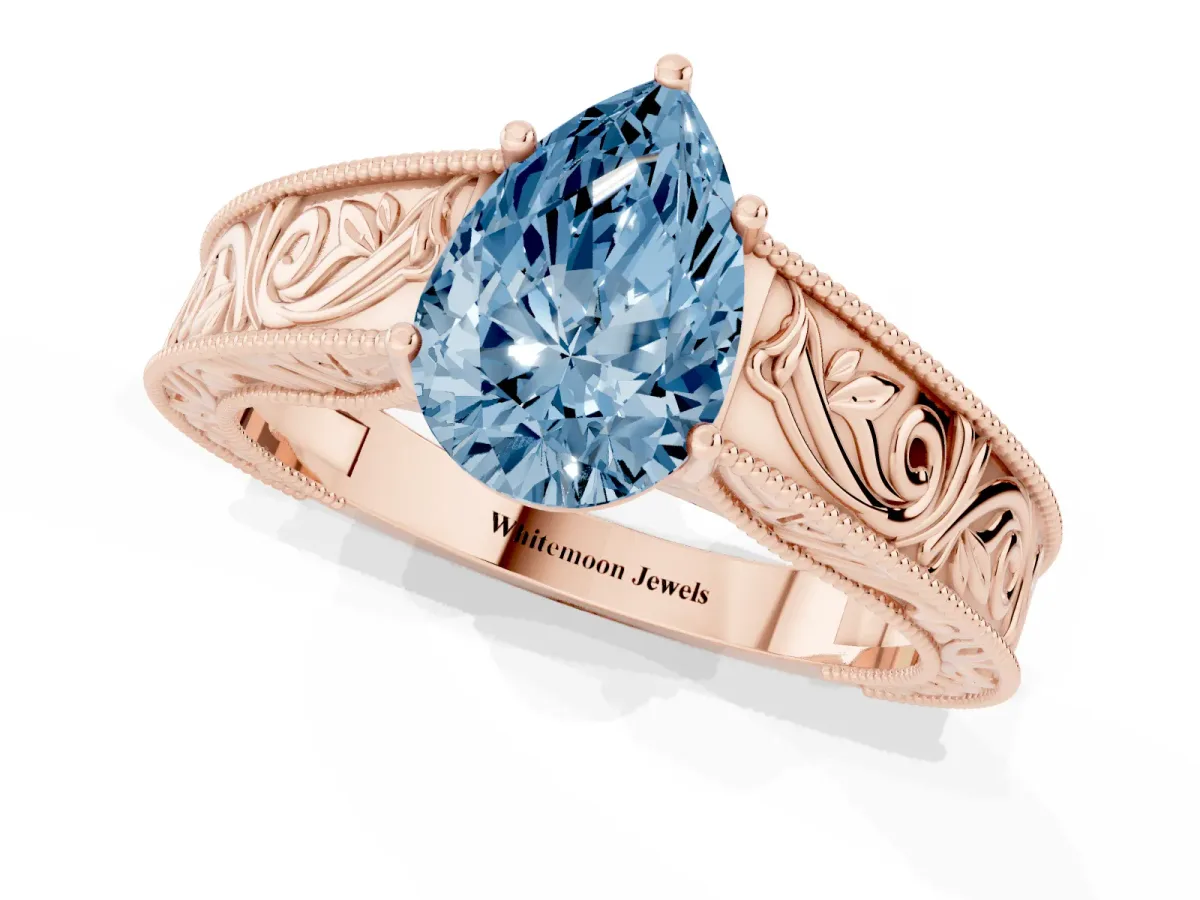 Fancy Blue Pear Cut Diamond Solitaire Ring with Engraved Band and Four-Prong Setting Rose gold