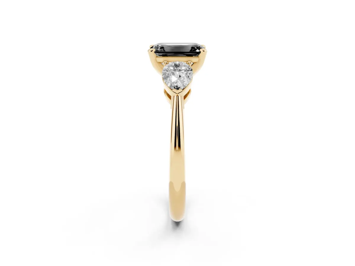 Fancy Black Three-Stone Emerald Cut Diamond Ring with Pear Side Stones and Four-Prong Setting Yellow gold