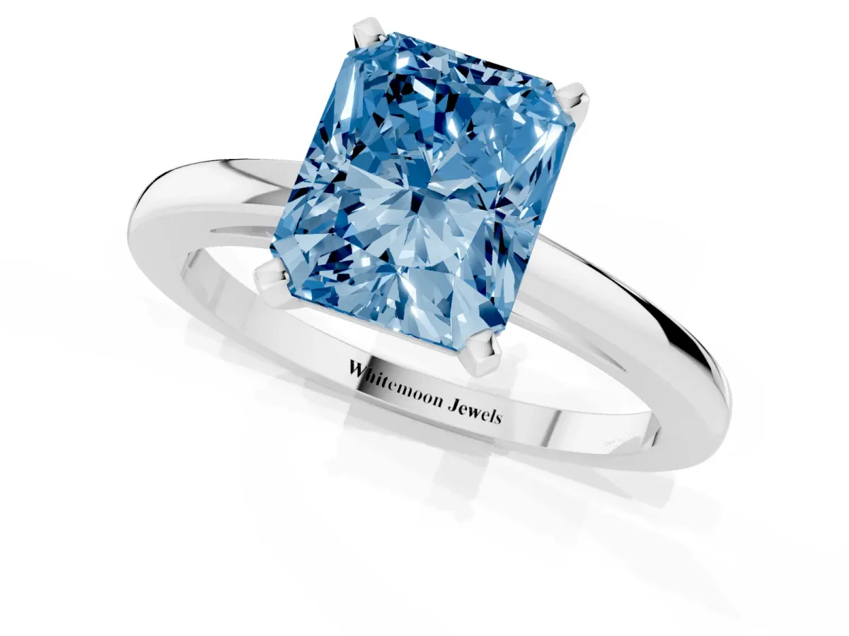 Fancy Blue Radiant Cut Solitaire Diamond Engagement Ring with Four-Prong Setting on a Classic Band Platinum