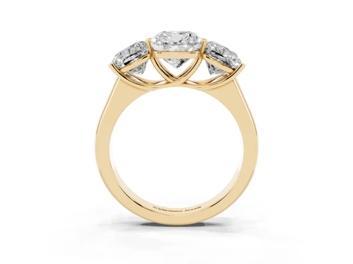 Cushion Cut Three-Stone Diamond Ring with Prong Setting on a Classic Band Yellow gold
