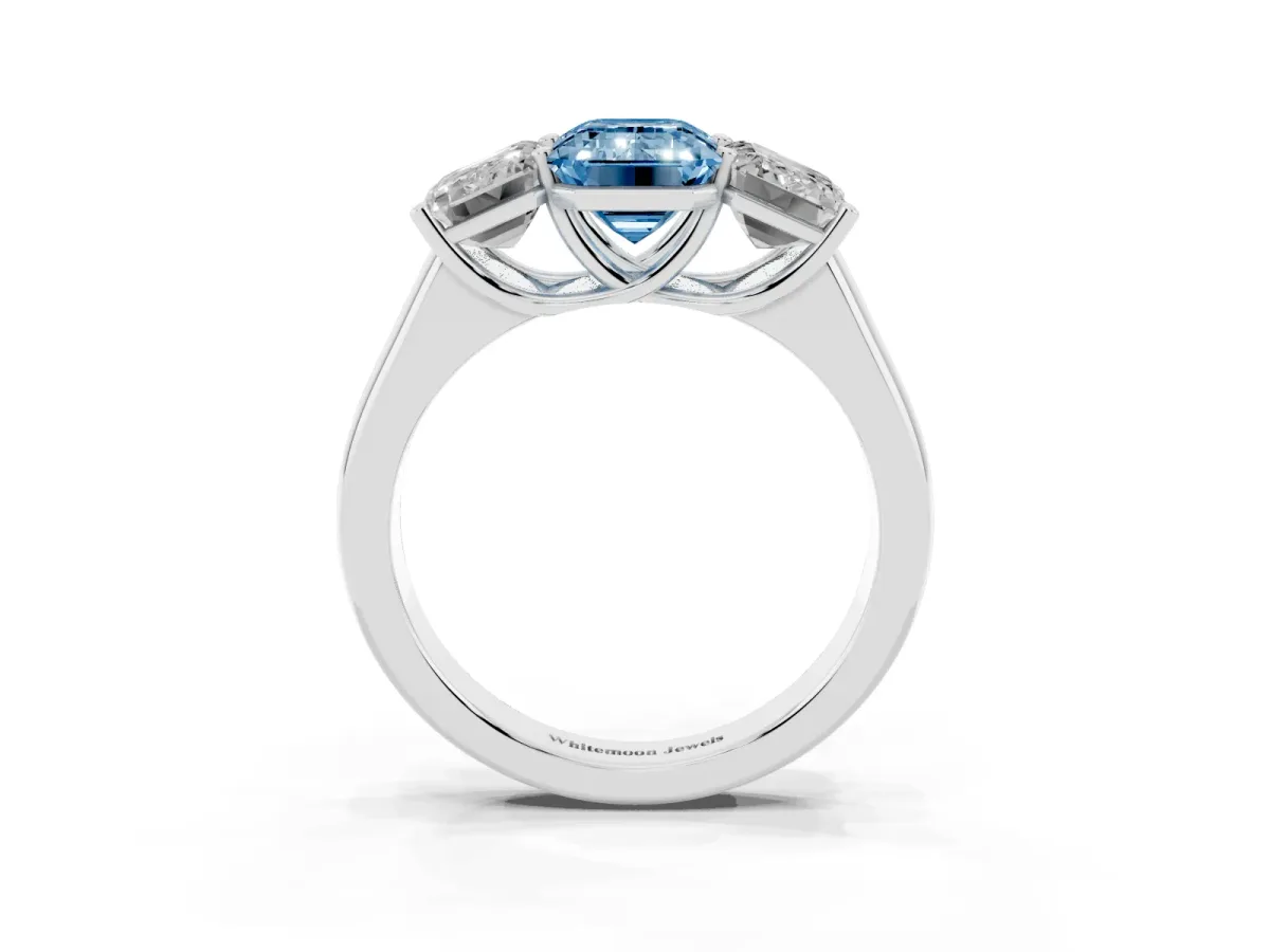 Fancy Blue Emerald Cut Three-Stone Diamond Ring with Prong Setting on a Classic Band Silver