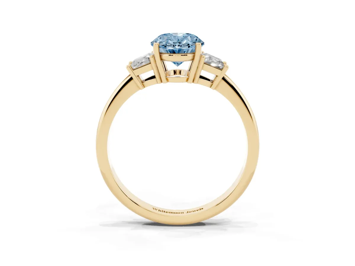 Fancy Blue Oval Cut Diamond Three-Stone Ring with Trapezoid Side Stones and Prong Setting Yellow gold