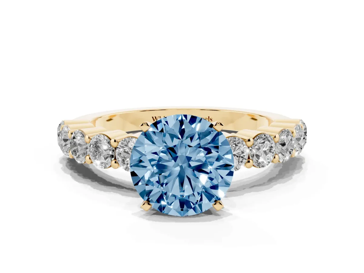 Fancy Blue Round Cut Diamond Solitaire Ring with Shared Prong Round Side Stones Yellow gold