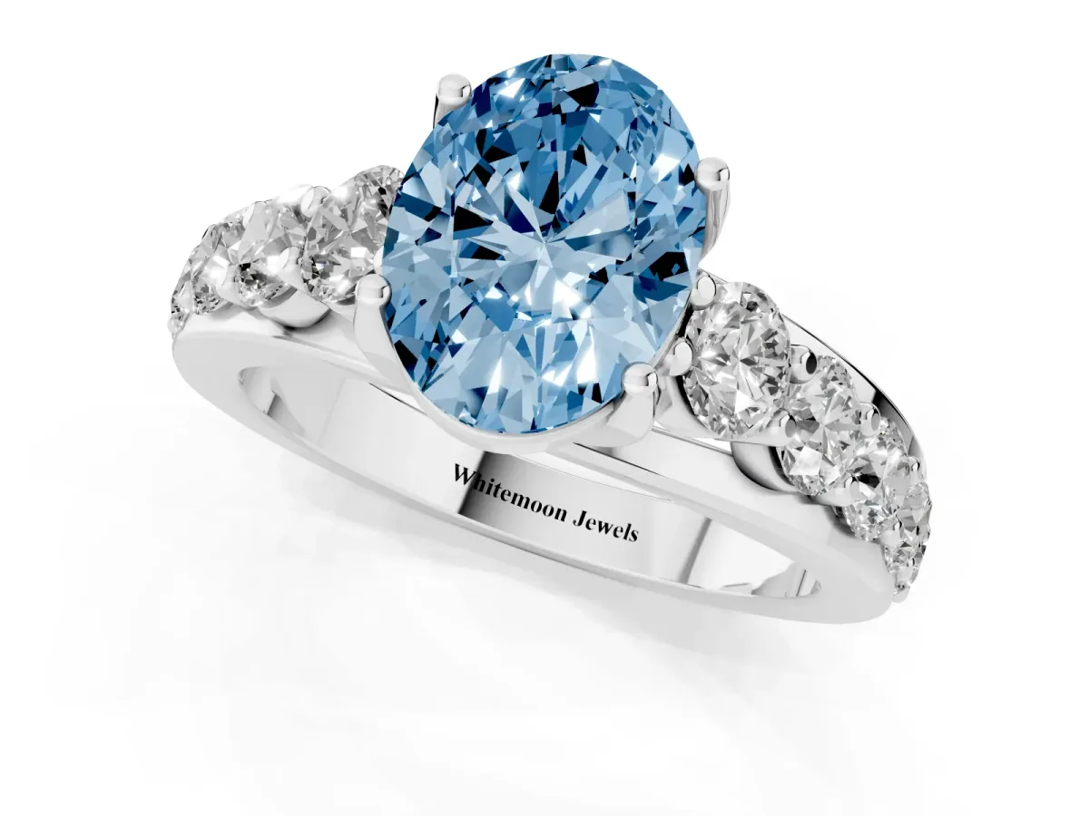 Fancy Blue Oval Cut Diamond Engagement Ring with Pavé Band and Four-Prong Setting Silver