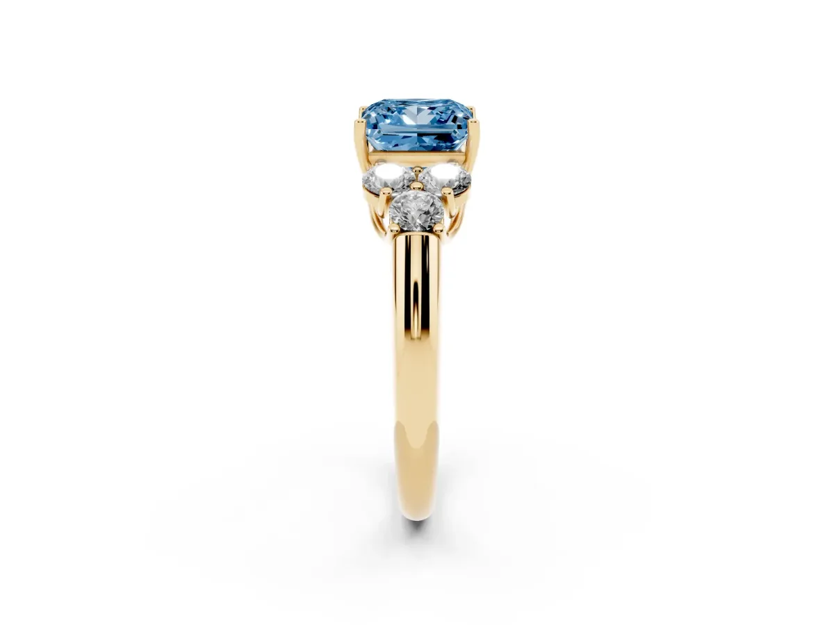 Fancy Blue Princess Cut Cut Diamond Cluster Ring with Round Accent Stones and Prong Setting on a Classic Band Yellow gold