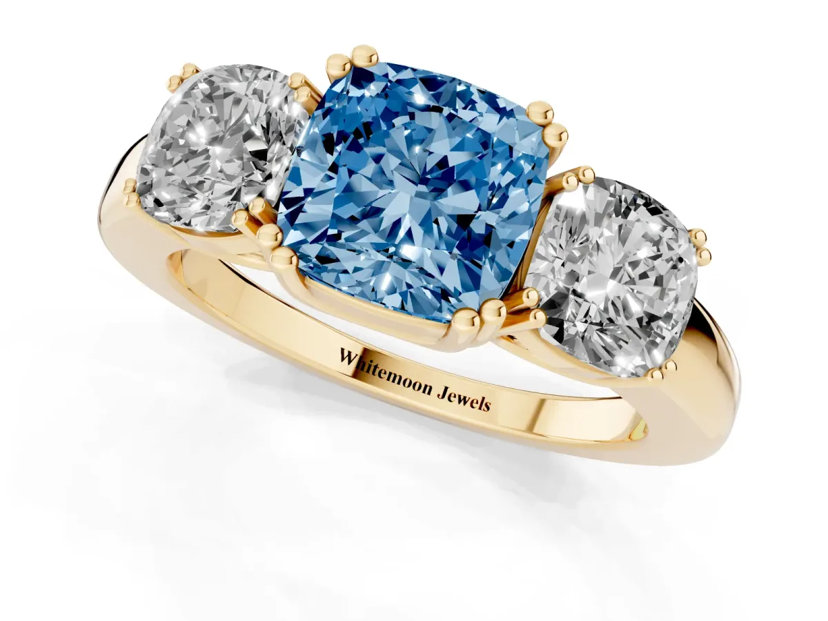 Fancy Blue Three-Stone Cushion Cut Cut Diamond Ring with Channel Set Band and Four-Prong Setting Yellow gold
