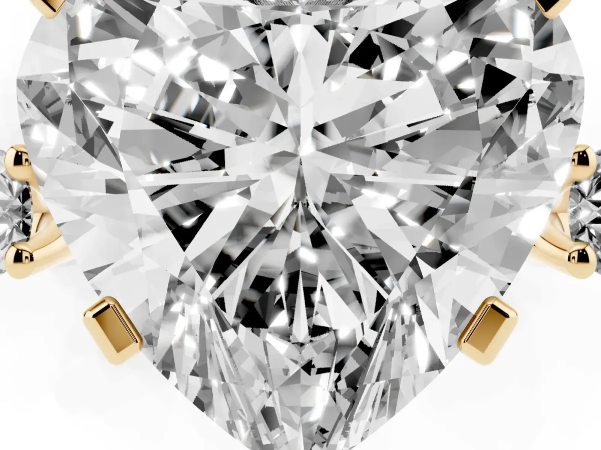 Heart Cut Cut Three-Stone Solitaire Ring with Round Accent Diamonds and Four-Prong Setting Yellow gold