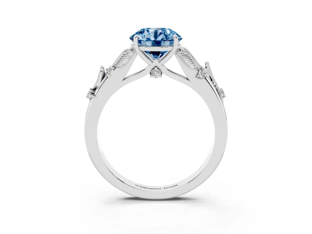 Fancy Blue Round Cut Diamond Solitaire Ring with Leaf Motif Band and Four-Prong Setting Silver