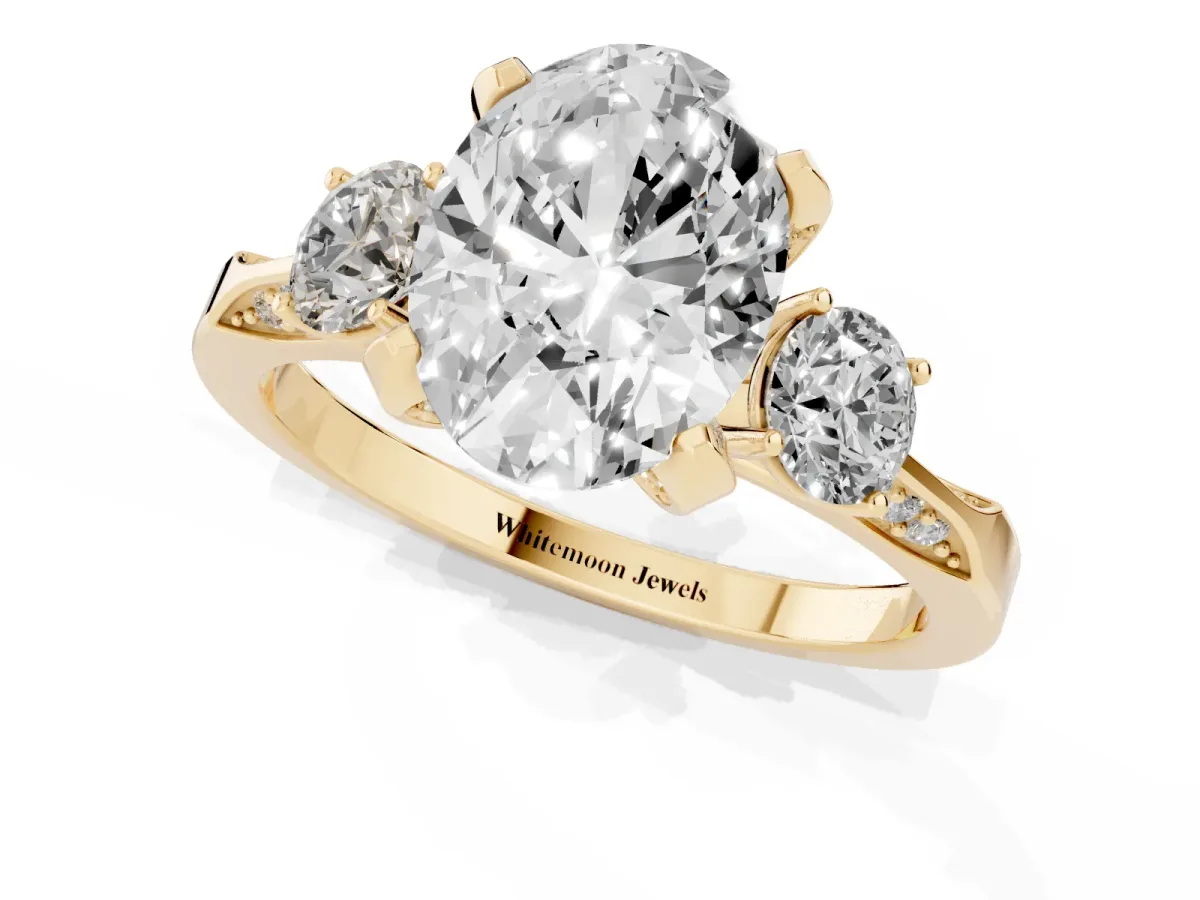 Oval Cut Brilliant Three-Stone Diamond Ring with Pavé Band and Four-Prong Setting Yellow gold
