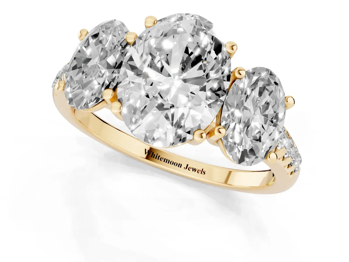 Three-Stone Oval Cut Diamond Ring with Round Pavé Band and Prong Setting Yellow gold