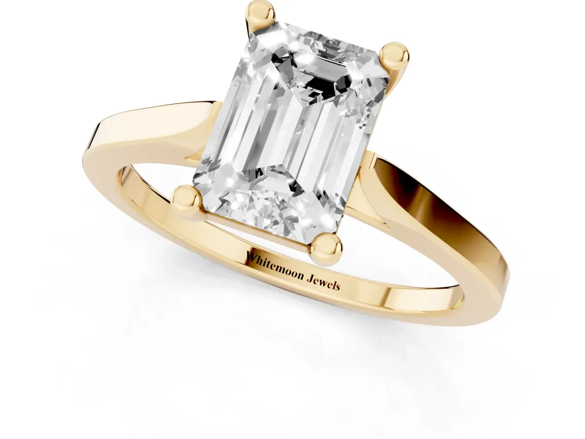 Emerald Cut Solitaire Diamond Ring with Four-Prong Setting and Tapered Band Yellow gold