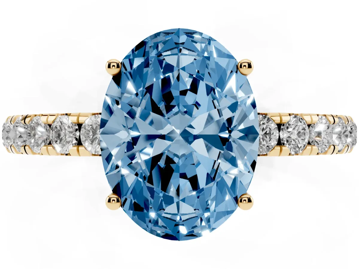 Fancy Blue Oval Cut Diamond Pavé Solitaire Engagement Ring with Four-Prong Setting Yellow gold