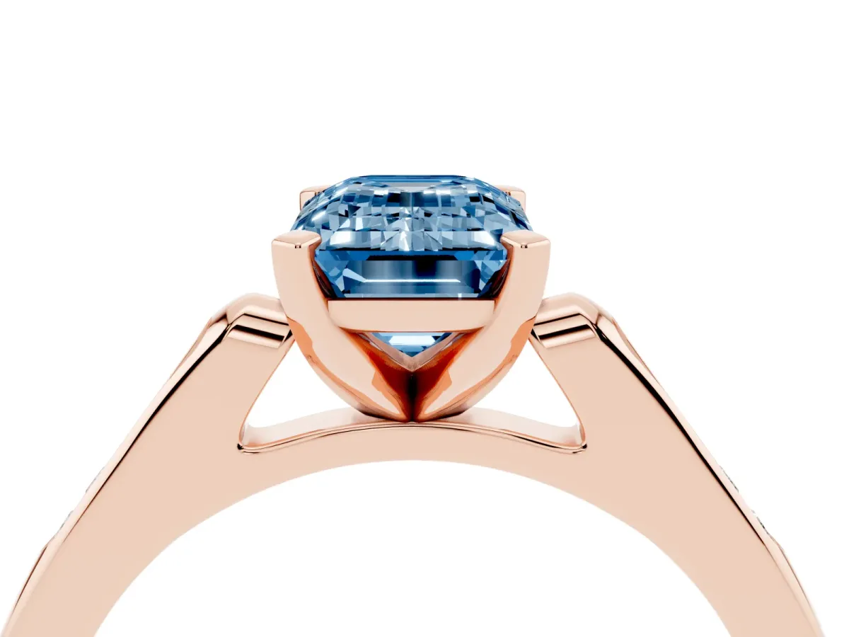 Fancy Blue Emerald Cut Diamond Solitaire Ring with Channel Set Round Band and Prong Setting Rose gold