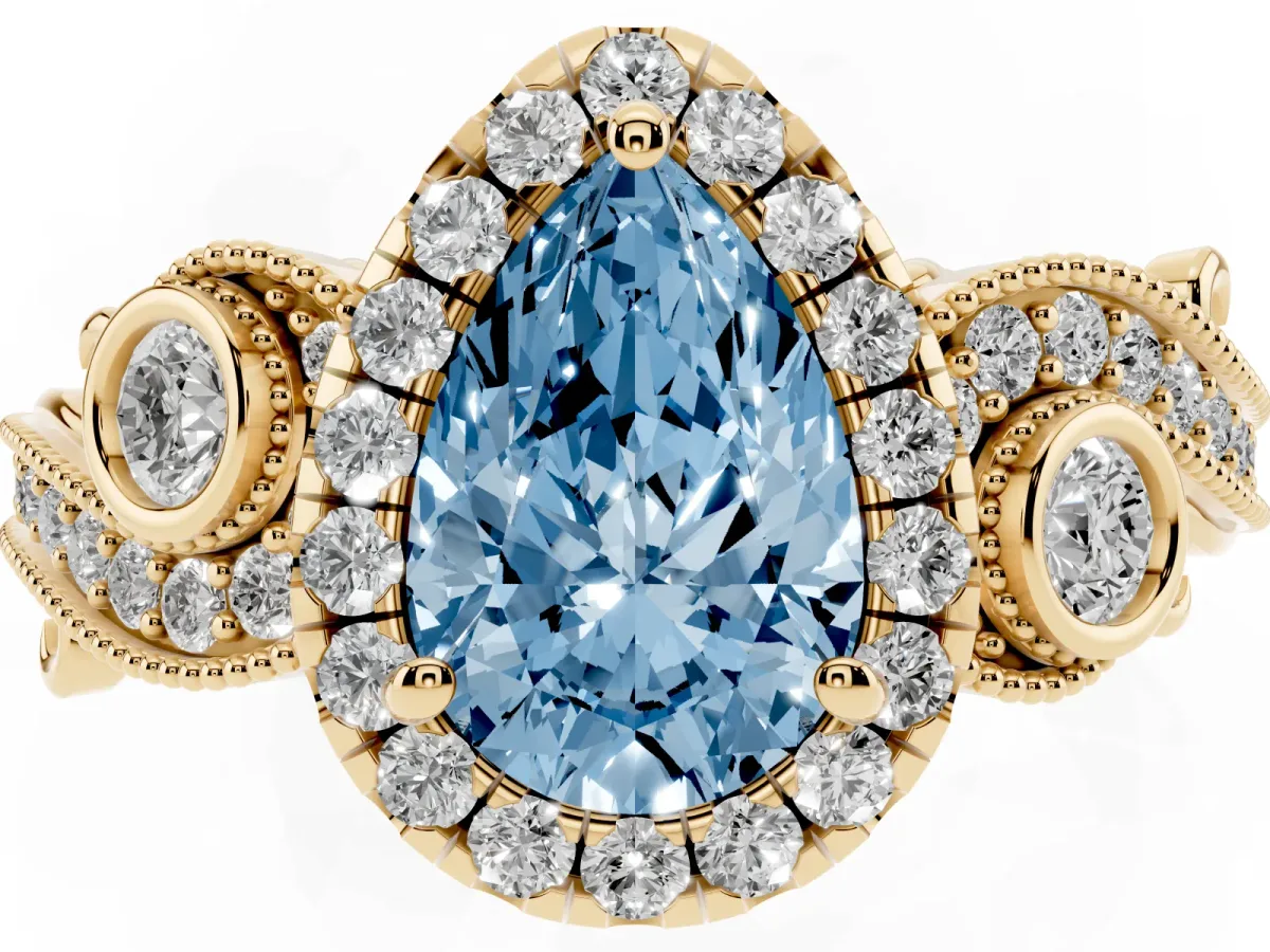 Fancy Blue Pear Cut Halo Diamond Ring with Milgrain and Bezel Accents on a Split Shank Band Yellow gold