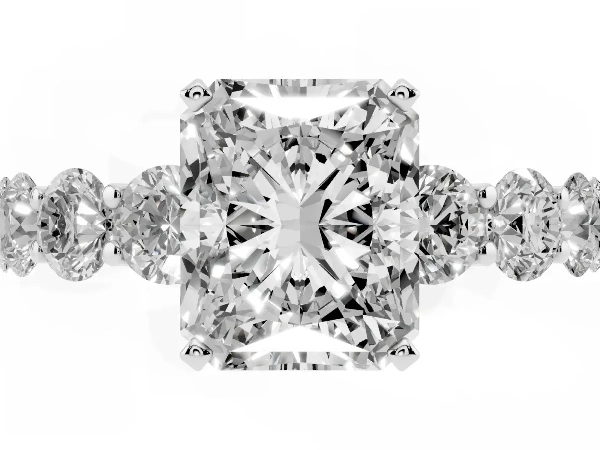 Radiant Cut Diamond Prong Setting with Side Stones on a Pave Band Silver