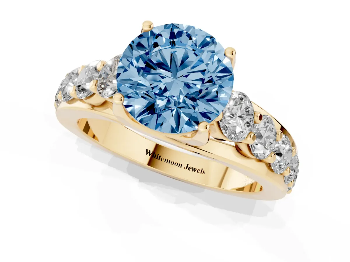Fancy Blue Round Cut Diamond Engagement Ring with Pavé Band and Four-Prong Setting Yellow gold