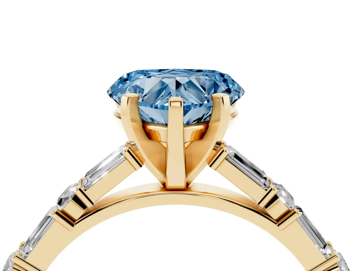 Fancy Blue Heart Cut Diamond Solitaire with Side Baguettes and Channel Set Band Yellow gold