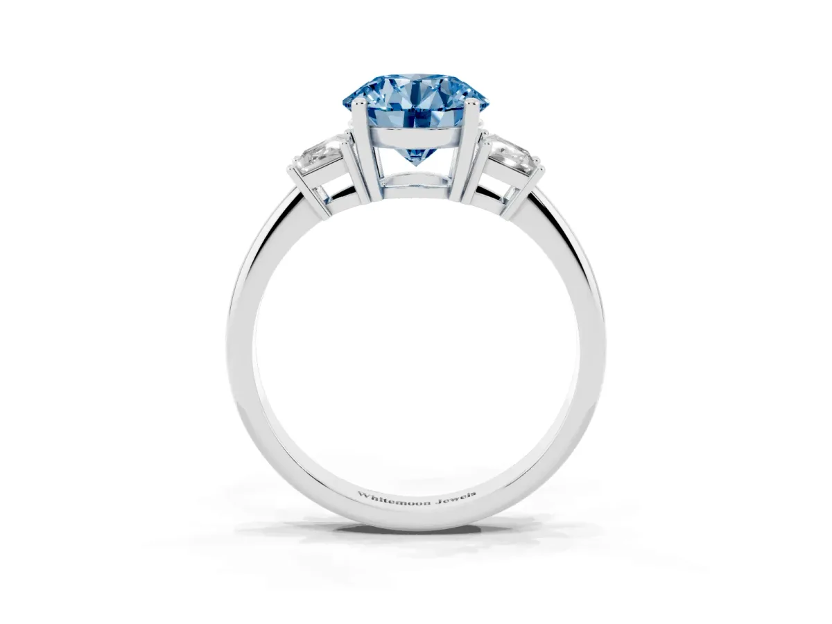 Fancy Blue Round Cut Diamond Three-Stone Ring with Trapezoid Side Stones and Prong Setting Platinum
