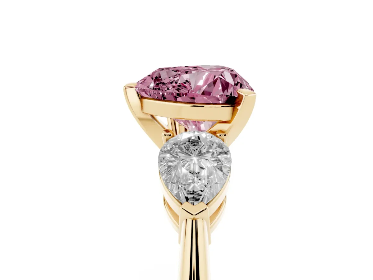 Fancy Pink Three-Stone Heart Cut Diamond Ring with Pear Side Stones and Four-Prong Setting Yellow gold