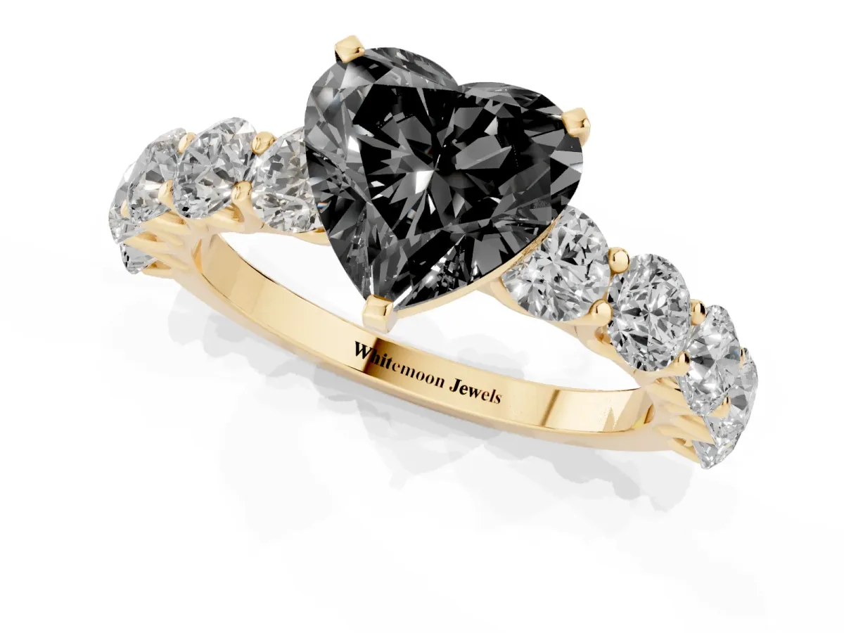 Fancy Black Heart Cut Diamond Prong Setting with Side Stones on a Pave Band Yellow gold