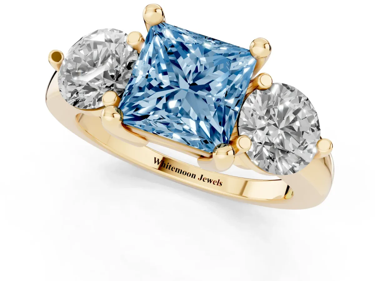 Fancy Blue Three-Stone Princess Cut Brilliant Cut Solitaire Ring with Prong Setting on a Classic Band Yellow gold