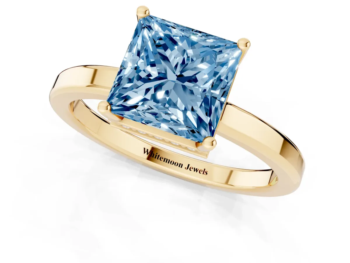 Fancy Blue Princess Cut Cut Solitaire Engagement Ring with Four-Prong Setting on a Classic Band Yellow gold
