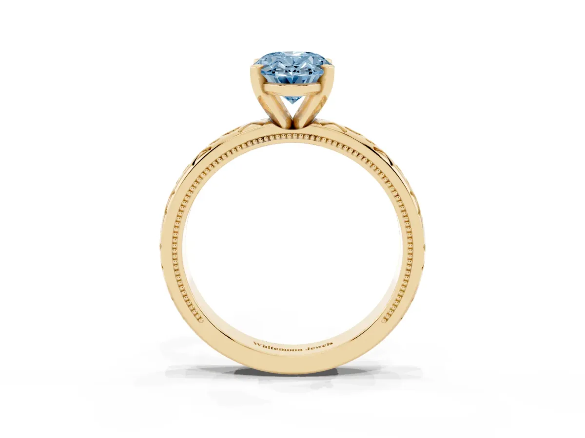 Fancy Blue Oval Cut Solitaire Engagement Ring with Scrollwork Band and Four-Prong Setting Yellow gold